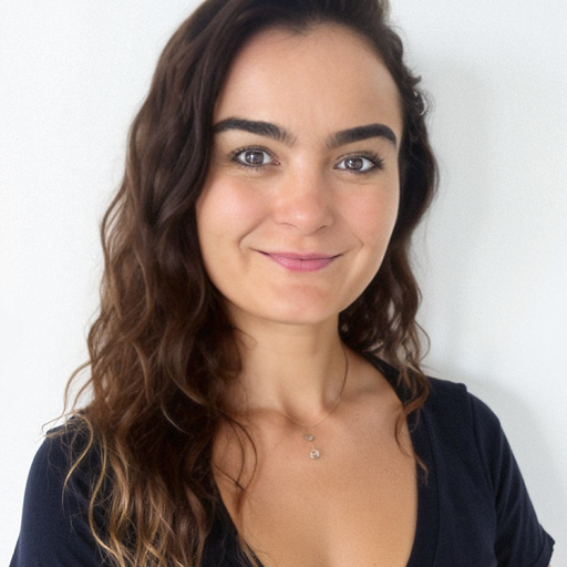 Jessica Coffey smiling in front of a plain wall